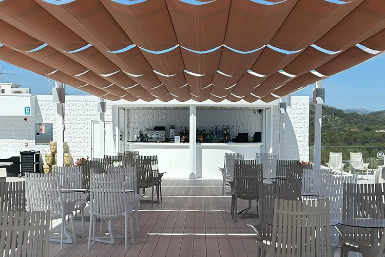 Sky Bar terrace with shaded tables and chairs at hotel Condesa